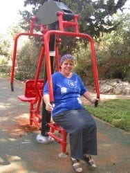 Woman sitting on exercise machine