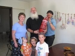 Sondra Baras and a man holding a fire extinguisher. Also in the picture Kim troup and 3 kids