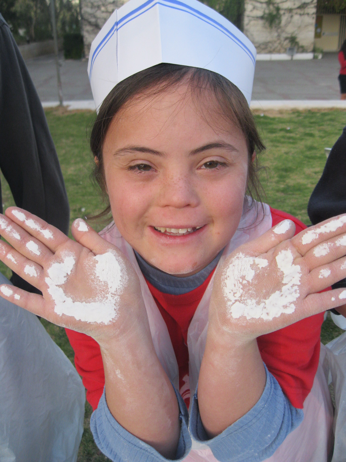 Levav smiling showing that she has paint on her hands