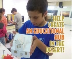 Young boy inspecting a model house