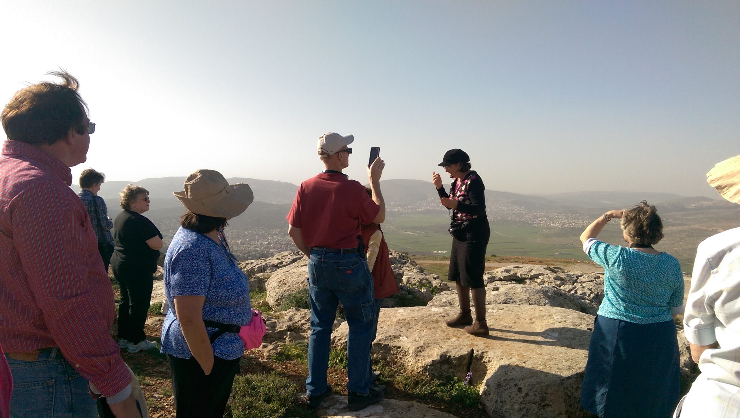 Sondra Baras speaks to a tour group at 3 Seas Outlook
