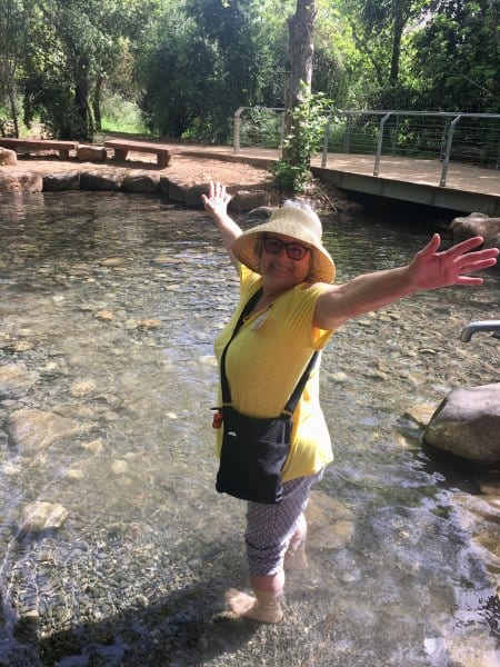 CFOIC tour participant wading at Tel Dan