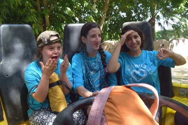 Riding a roller coaster during a Passover Camp with Heart of Benjamin child and volunteers